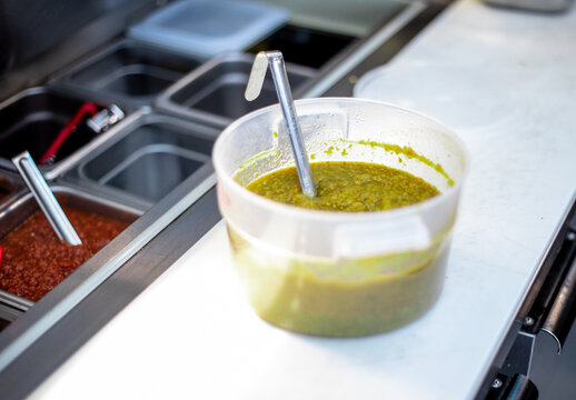 Vat of Salsa Verde at Food Truck plating station with ladel