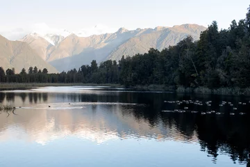 Keuken foto achterwand Reflectie Landscape of a mountain lake with mountains and a glacier in New Zealand. The mountains are reflected in the lake.