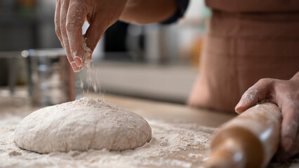 Woman hands kneading dough in the kitchen