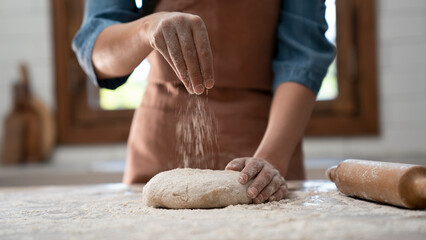 Woman hands kneading dough in the kitchen