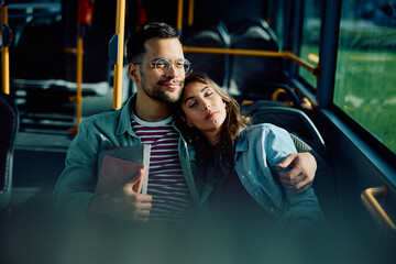Young couple in love commuting by bus.