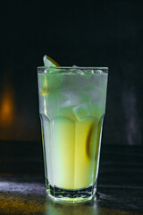 cocktail on a dark background with ice and fruits. menu format
