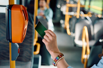 Close up of woman scanning her bus pass.