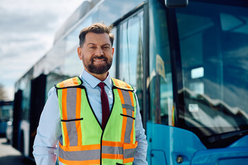 Happy mid adult bus driver looking at camera.