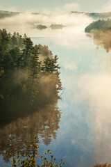 High angle view of boundary waters lake and trees in morning fog in Minnesota during autumn