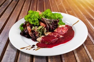 Roasted tasty meat sliced on plate with herbs and spices