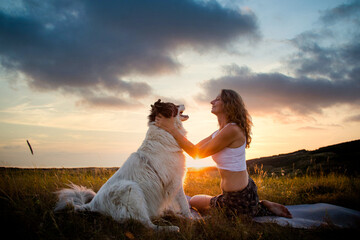Fototapeta na wymiar happy woman and dog enjoying sunset
