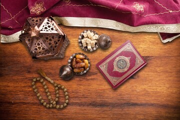 Plate with dates tasty sweets on wooden desk