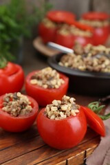 Delicious stuffed tomatoes with minced beef, bulgur and mushrooms on wooden table