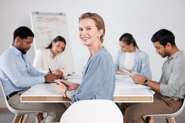 Im lending my experience. Cropped portrait of an attractive mature businesswoman sitting in the boardroom during a meeting with her colleagues.