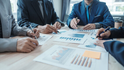 Team of male bookkeepers people working with balance sheet to analyze problems and find solutions to develop business organization and company's stock market system. Common stock and preferred stock