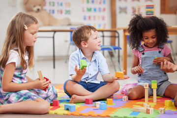 Giving children the freedom to play helps them learn. Shot of a group of preschool students playing...