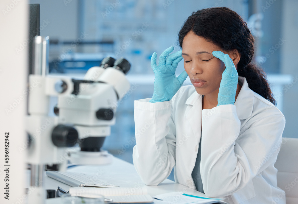 Poster theres no need for this. shot of a young lab worker experiencing a headache while at work.