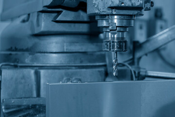 The tapping process on NC milling machine in the light blue scene.
