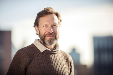 Fototapeta premium Portrait of a handsome middle aged man with beard and mustache smiling outdoors