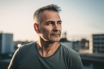 Fototapeta premium Handsome middle-aged man with short hair in urban environment