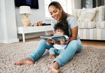 Making the most of these important moments. Shot of a young mother reading to her baby girl.