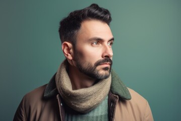 Portrait of a handsome young man wearing warm clothes and scarf.