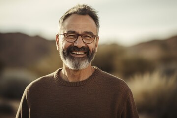 Portrait of a smiling senior man wearing eyeglasses in the desert