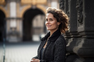 Naklejka na ściany i meble Full-length portrait photography of a grinning woman in her 30s wearing a chic cardigan against a historic monument or landmark background. Generative AI
