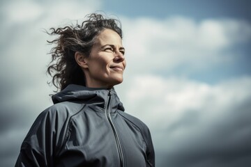 Group portrait photography of a cheerful woman in her 40s wearing a comfortable tracksuit against a sky and clouds background. Generative AI
