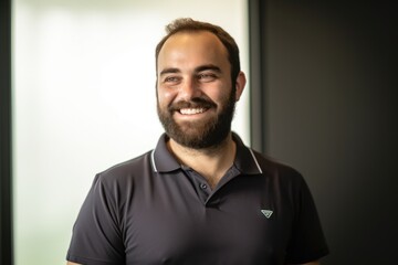 Fototapeta premium Portrait Of A Happy Young Man Smiling At Camera In Office