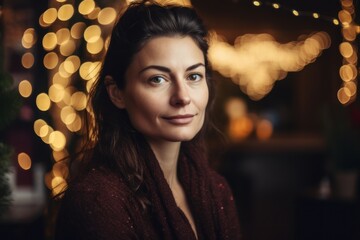 Portrait of a beautiful young woman on a background of Christmas lights.