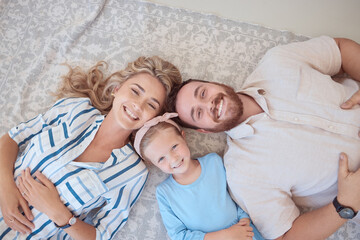 Portrait of happy smiling caucasian family from above relaxing on a carpet floor at home. Carefree...