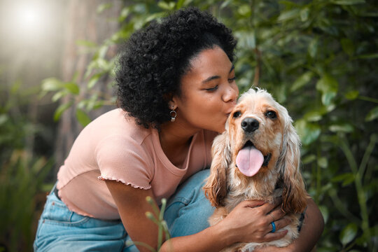 Mommy loves you. Cropped shot of an attractive young woman and her Cocker Spaniel puppy outside.