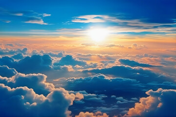 View above the clouds with a blue sky and a bright sun. summer solstice in the orange, white, and blue clouds.