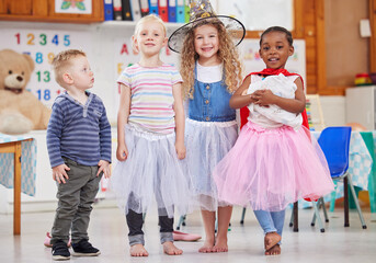 Fototapeta na wymiar We love dressing up and playing together. Shot of a group of preschool children playing dress-up in class.