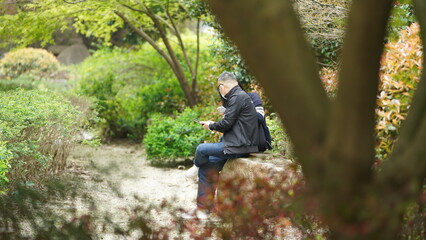 The people playing and walking in the isolated garden during the Covid19 period