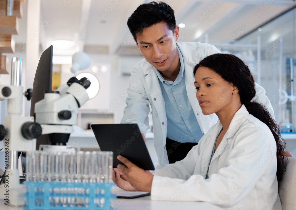 Aufkleber Double the brain power. Shot of two lab techs working together while using a digital tablet.