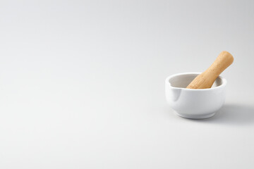 mortar and wooden pestle for cooking or medicine, isolated white background