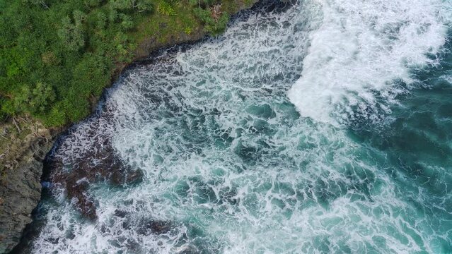 Aerial view of the waves hitting the rocks