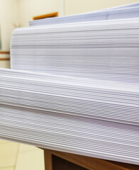 A stack of blank paper, book blocks prepared for binding in a printing house