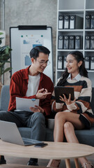 Good news by mail. Happy married asian chinese couple sit at home office by paperwork business accounting. Glad young spouses read financial report get profit tax refund check information using laptop