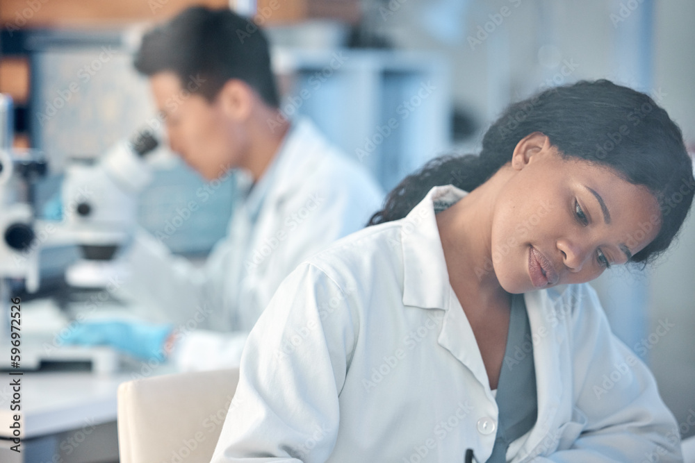Poster making the most of every moment. shot of two coworkers peacefully working together in a lab.