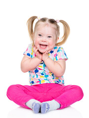 Happy little girl with Downs syndrom looks at camera. Isolated on white background