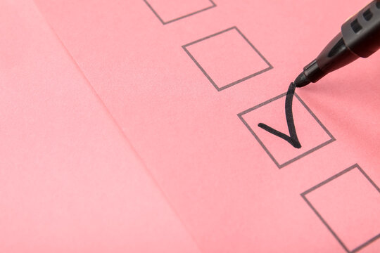 Black pen marking on checklist box, closeup