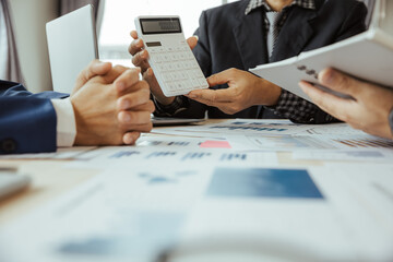 Team of business people in a meeting to analyze business growth plans for future new business expansion using laptop computers and tablets for work