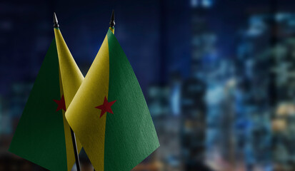 Small flags of the French Guiana on an abstract blurry background