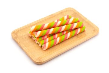 Wafer stick roll in wooden tray isolated on white background. colorful wafer stick rolls.