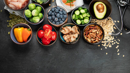 Food for a healthy heart concept and  stethoscope on black background