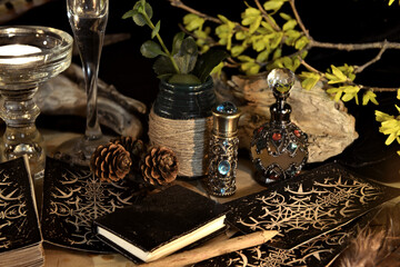 Esoteric and occult still life with vintage magic objects, tarot cards, book and candle on witch table altar for mystic rituals and fortune telling. Halloween and gothic background