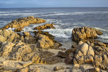 Fototapeta na wymiar rocks at seashore late afternoon at Pebble Beach Carmel California