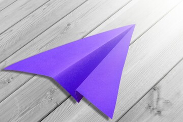 Purple colored paper plane on background