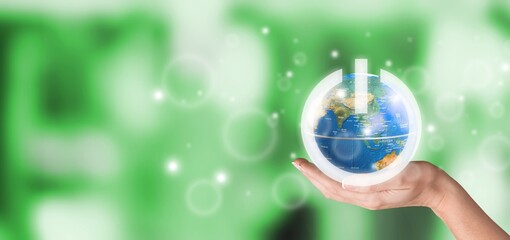 Globe of Earth with image of power button in hand