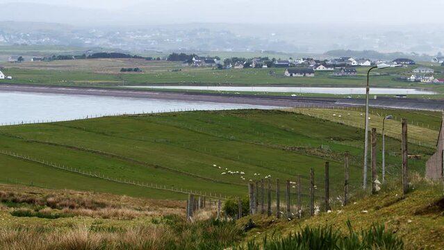 Shot of crofts and fields around Point as well as The Braighe road near Stornoway, which is visible in the distance. Filmed on the Isle of Lewis, part of the Outer Hebrides of Scotland.