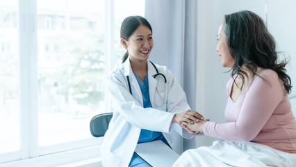 Fototapeta premium Asian Chinese female physiotherapist caregiver helping elderly woman exercise for recovery, prevention of osteoarthritis and osteoporosis.